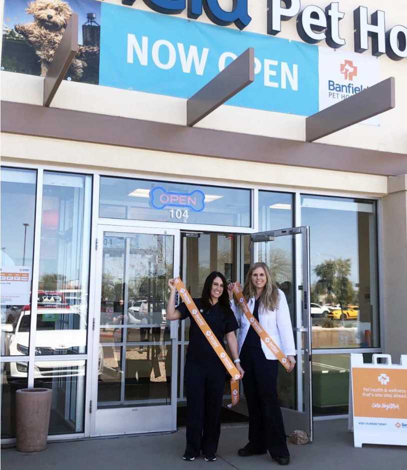 A couple of young female Banfield associates standing at the entrance of the Banfield Pet Hospital