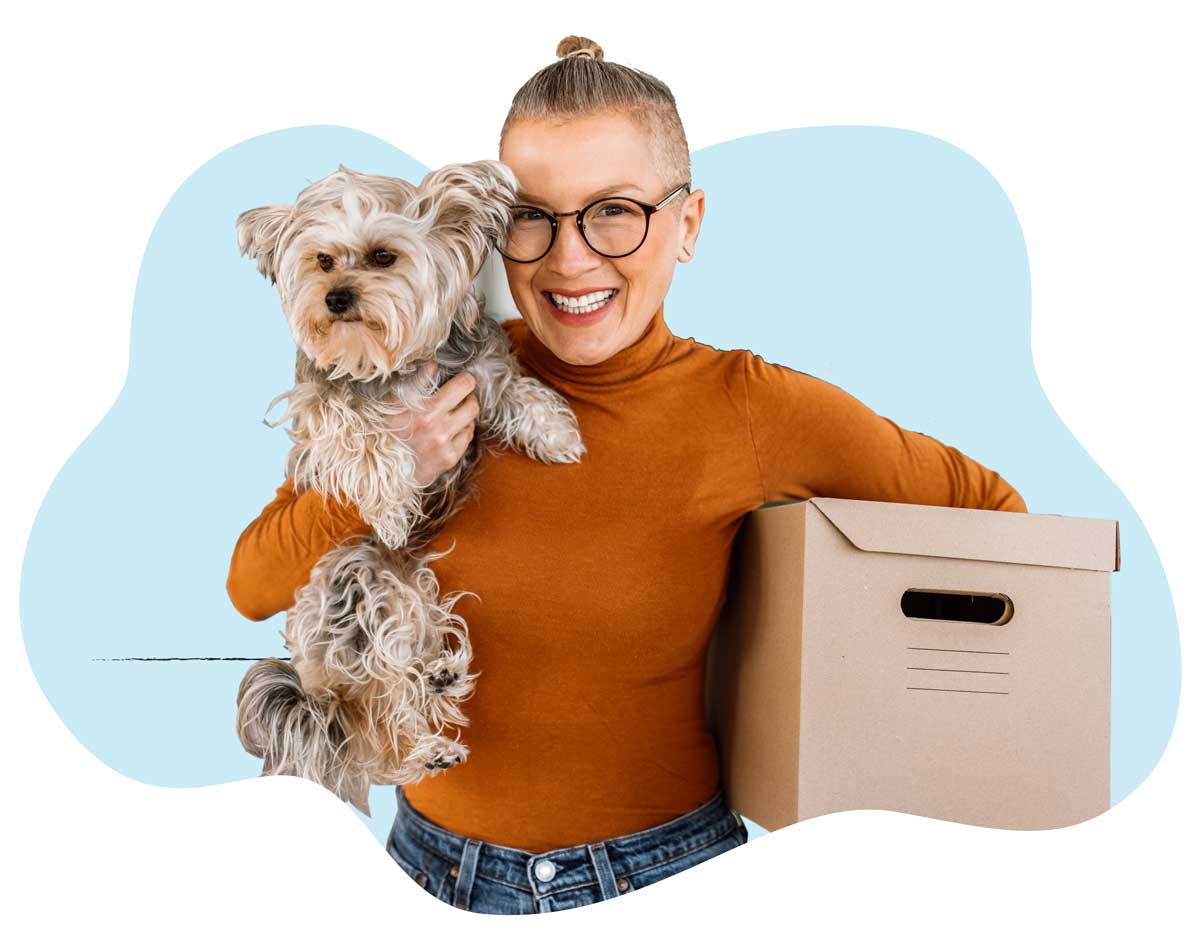 20250423_020 A woman in an orange sweater holding her small brown dog
