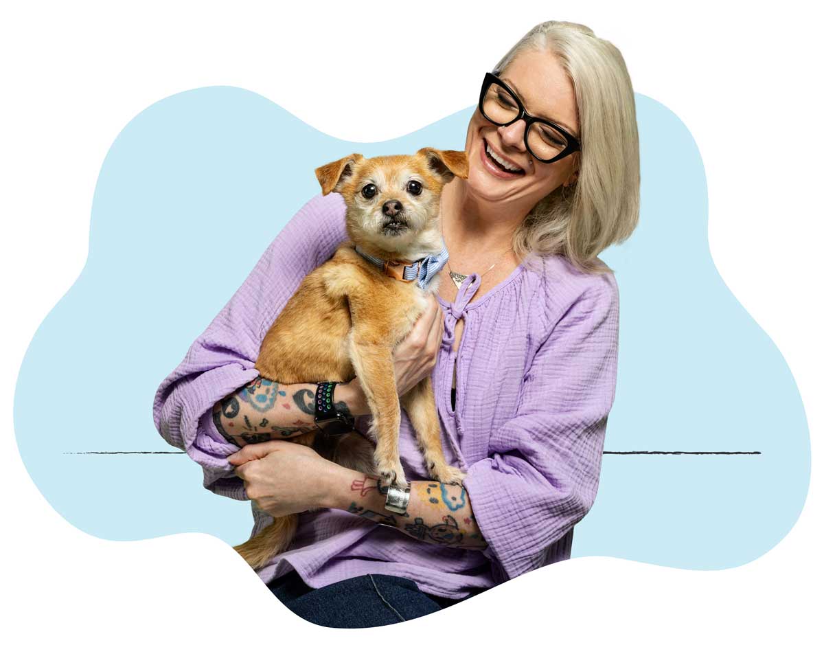 20250423_030 Michelle Slater-Young, Creative Services Director, sitting with her dog in her lap