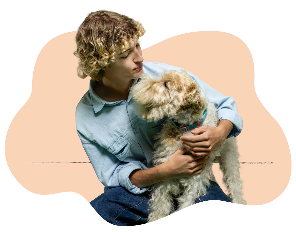 20250423_029 A man in a light blue shirt holding his Schnauzer in his lap