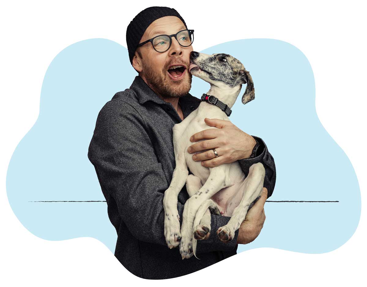 20250423_032 A man in a gray long-sleeve shirt gets a kiss from his dog