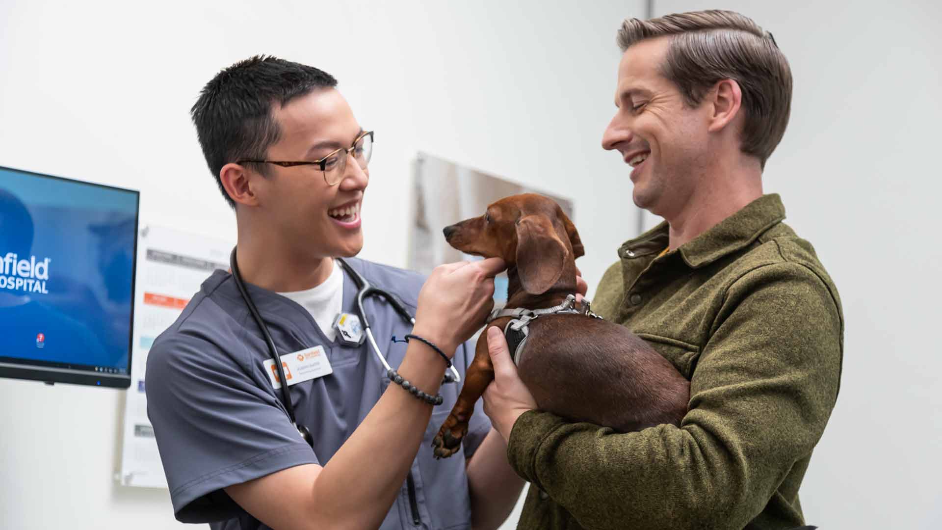 Veterinary assistant Joseph Slater welcomes a client and his Dachshund.