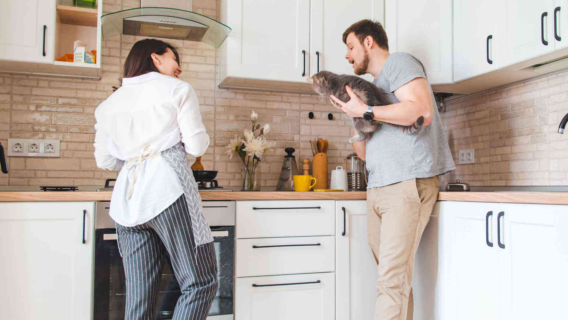 Cat with owners at kitchen