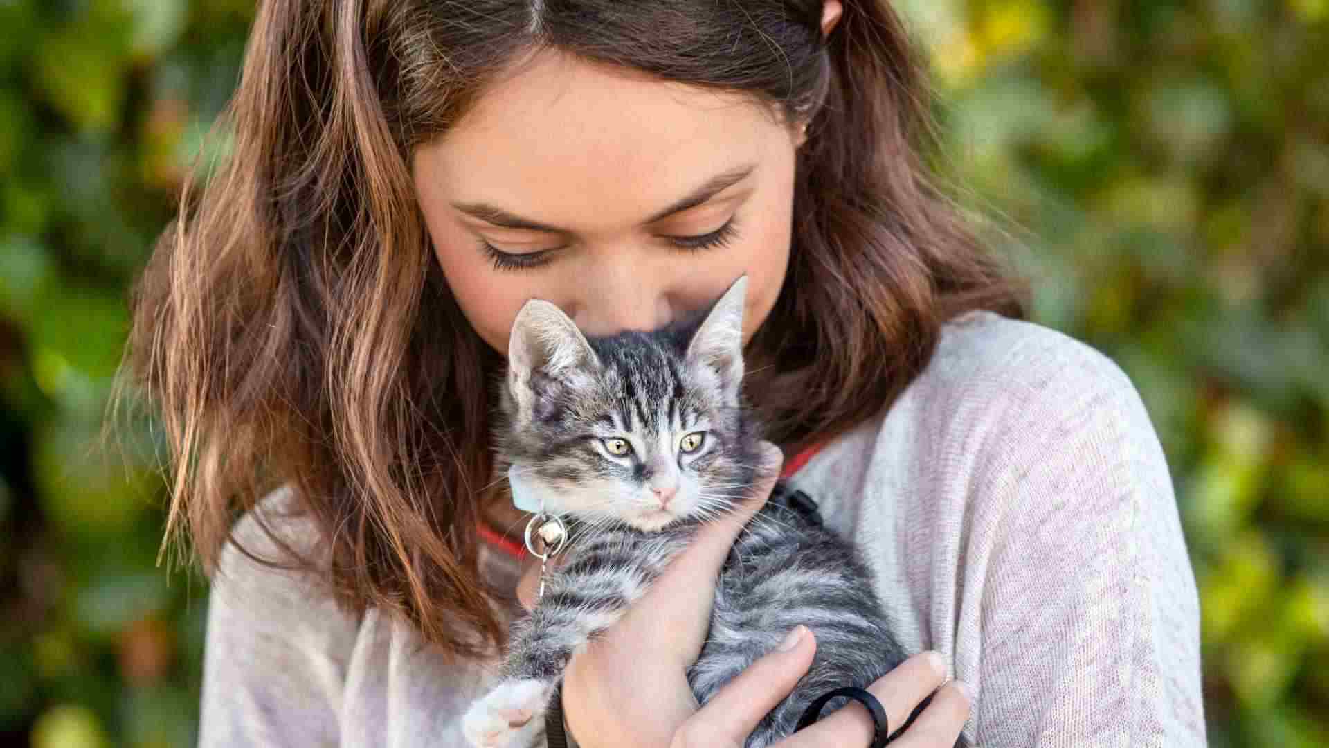 girl kissing her cat