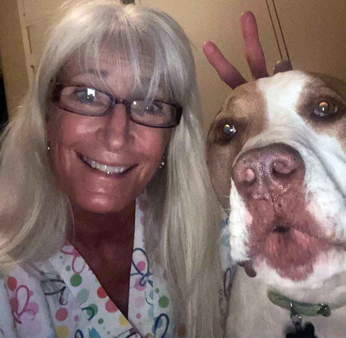 A selfie of a female dog owner with her dog