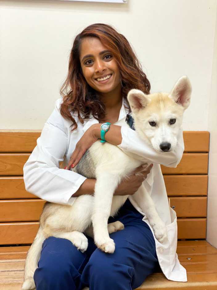 A female Banfield veterinarian with a dog