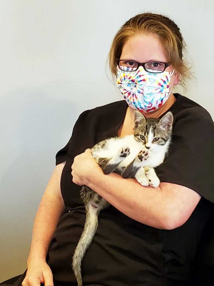 A female associate holding a kitten at the Banfield Pet Hospital, Yadkin Park, NC