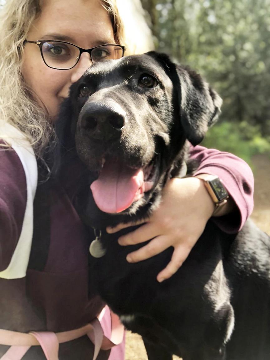 Selfie of a dog owner and her black dog