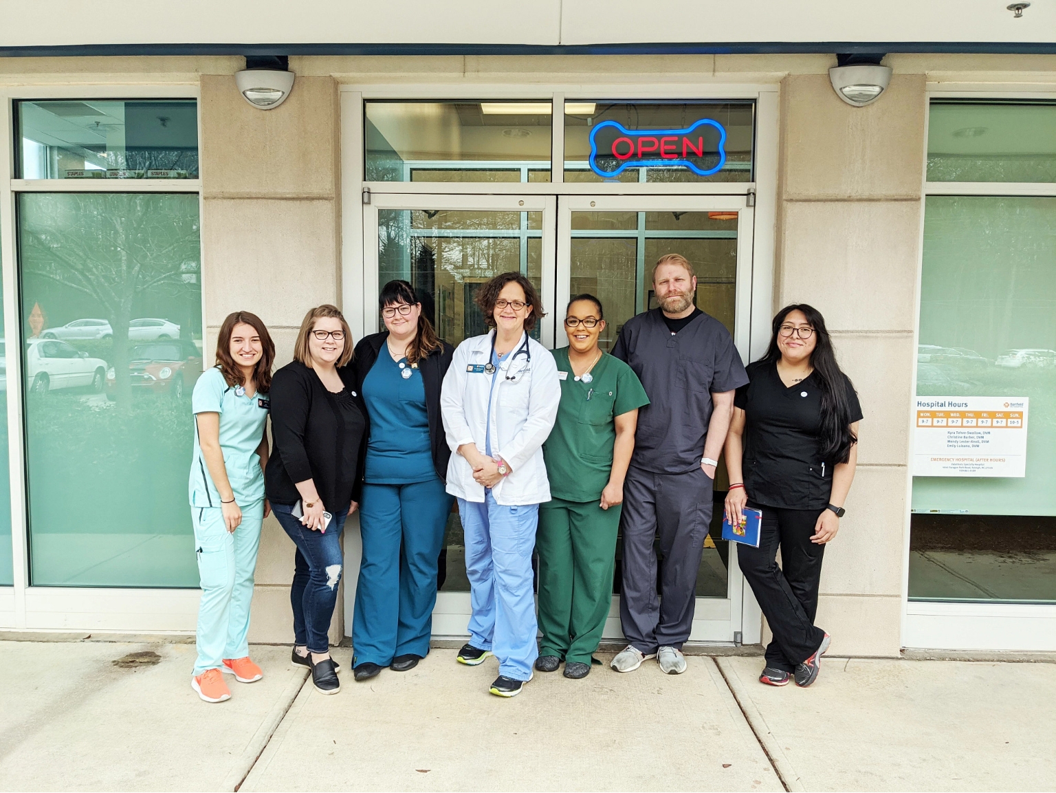  A group of Banfield Associates standing outside the Banfield Pet Hospital, Raleigh Falls Pointe, NC 